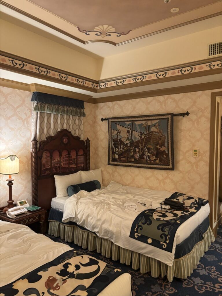 Guest room at Hotel MiraCosta in Tokuo DisneySea featuring elegant decor and twin beds with Disney-themed bedding