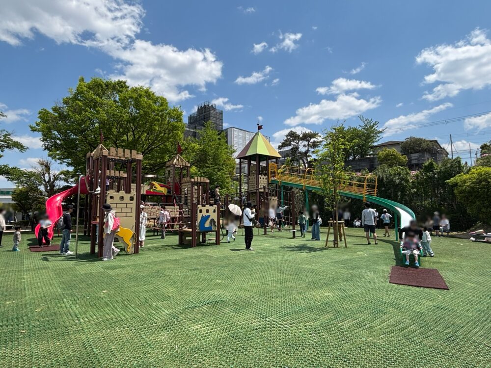 Connected playground equipment with a long slide, small slide, and rope bridge at Hanshin Racecourse